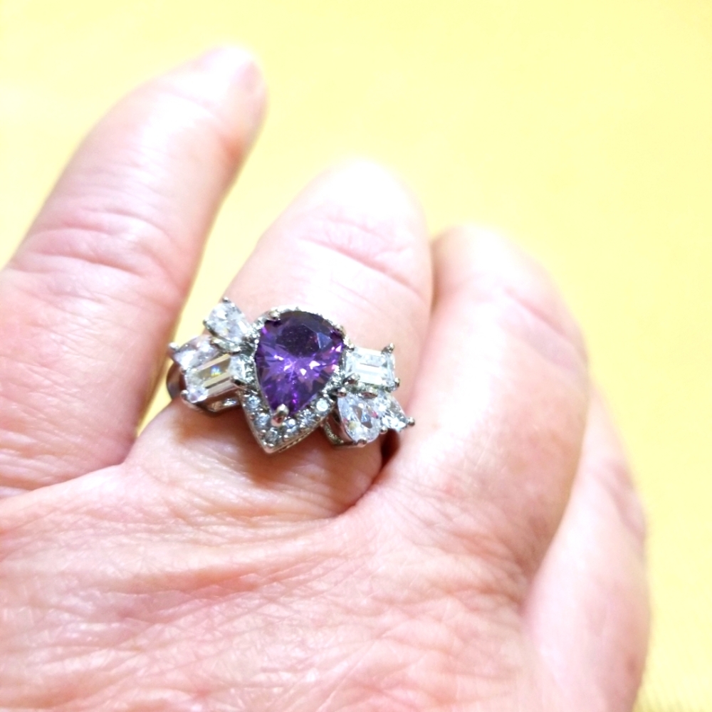 RING PURPLE FAUX TEARDROP STONE W FAUX DIAMOND OF DIFFERENT SHAPES SURROUNDING